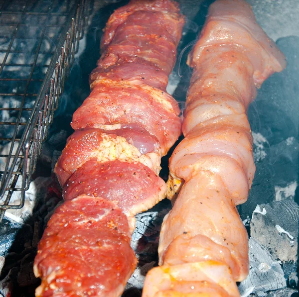 Grilling marinated meat on a charcoal grill — Stock Photo, Image