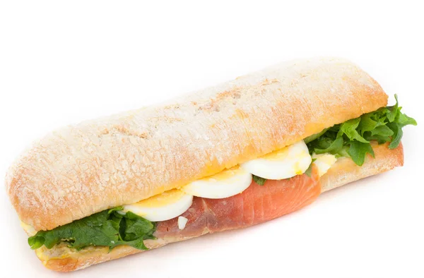 Real sandwich with smoked salmon, eggs and green on a white background. — Stock Photo, Image