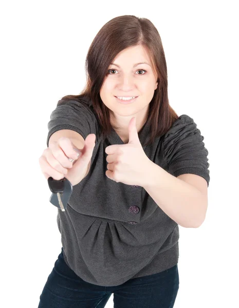 Junge schöne Frau zeigt Autoschlüssel auf weißem Hintergrund — Stockfoto