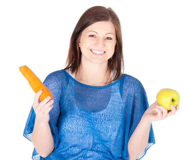 Young woman chose between apple and carrot over white background — Stock Photo, Image