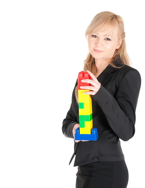 Young beautiful business woman with plastic blocks posing on white background — Stock Photo, Image