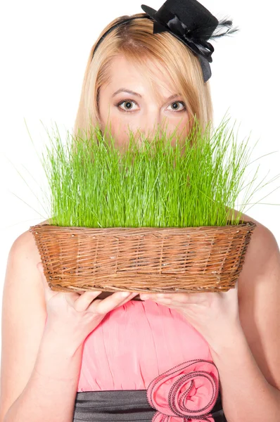 Woman holding easter basket with green grass — Stock Photo, Image