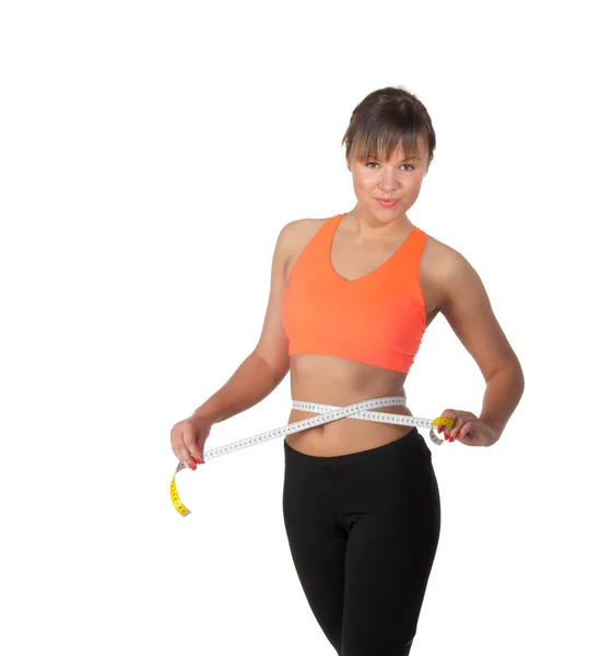Beautiful slim woman measuring her waistline with a measuring tape — Stock Photo, Image