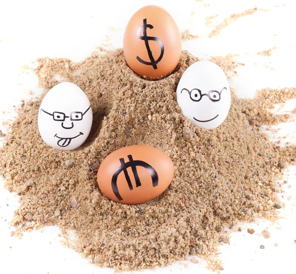 Image of big white eggs with dollarand euro signs on a sand — Stock Photo, Image