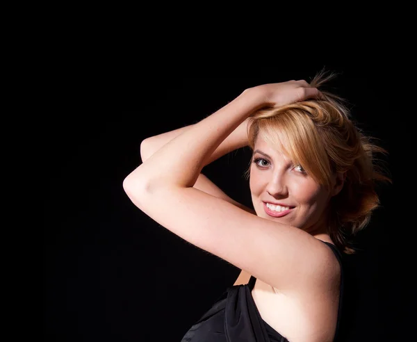 Woman in black dress over dark background — Stock Photo, Image