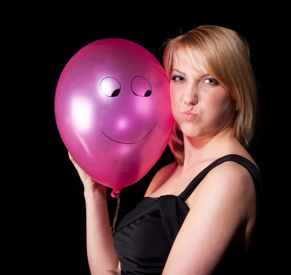 Woman in black dress with air ball over dark background — ストック写真