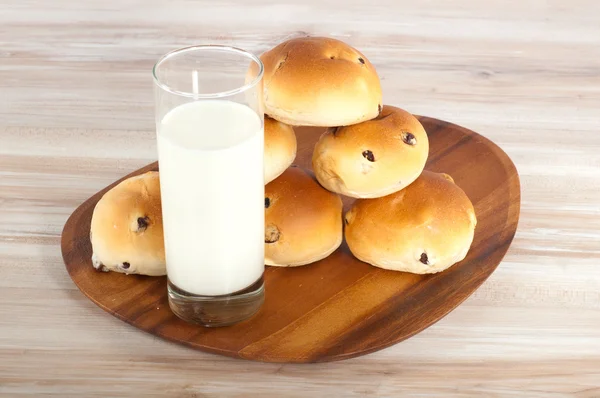 Group of hot cross buns and milk on a wooden board — Stock Photo, Image