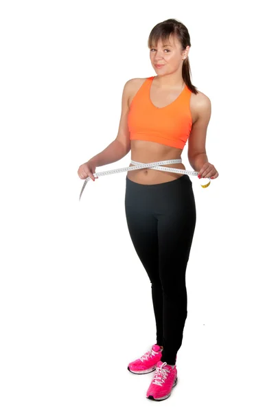 Beautiful slim woman measuring her waistline with a measuring tape — Stock Photo, Image