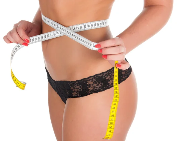 Mujer que mide la forma perfecta de hermoso muslo saludable . — Foto de Stock