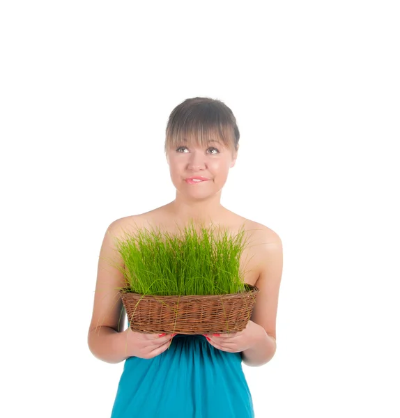Beautiful woman holding easter basket with green grass — Stock Photo, Image
