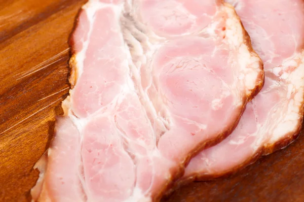 Close up image of ham in wooden plate — Stock Photo, Image