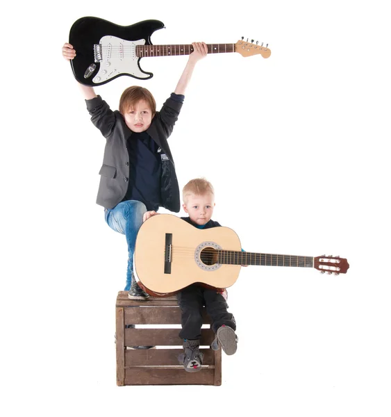 Two boys with guitars on a box — Stock Photo, Image