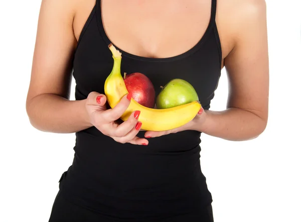 Mooie fitness jonge vrouw met bananen en appels. — Stockfoto