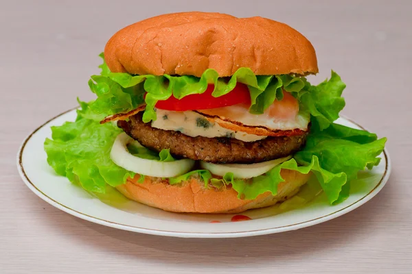 Tasty homemade burger on a plate — Stock Photo, Image