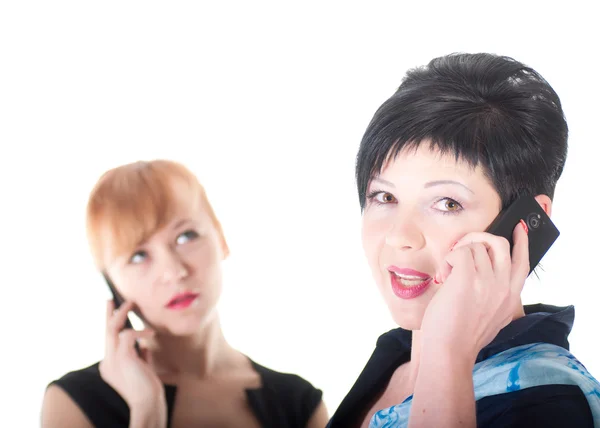 Two business women talking by cell phones — Stock Photo, Image