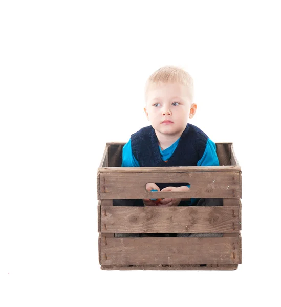 Little boy in wooden box — Stock Photo, Image