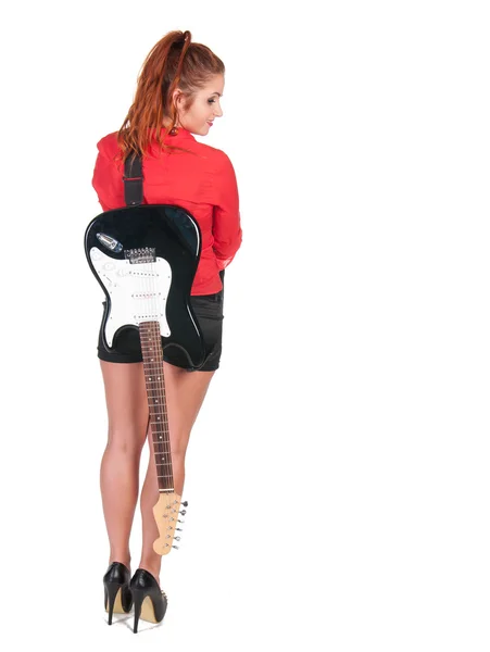 Pretty woman in black shorts posing with guitar — Stock Photo, Image