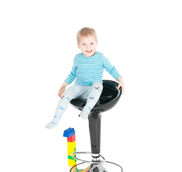 Little boy sitting in a chair — Stock Photo, Image