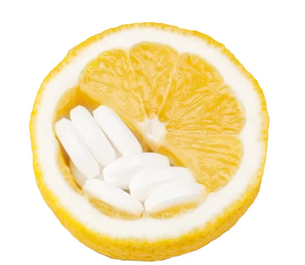 Close up of lemon and pills isolated - vitamin concept — Stock Photo, Image
