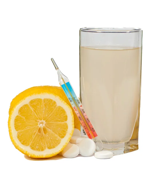 Closeup of effervescent tablets, lemon, thermometer and glass — Stock Photo, Image