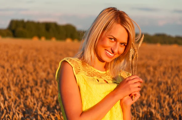 Happy womanin yellow dress in golden wheat — Stock Photo, Image