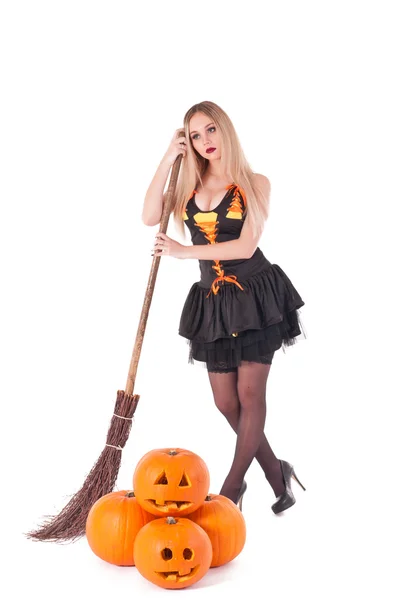 Halloween witch in dress with pumpkin, broom — Stock Photo, Image