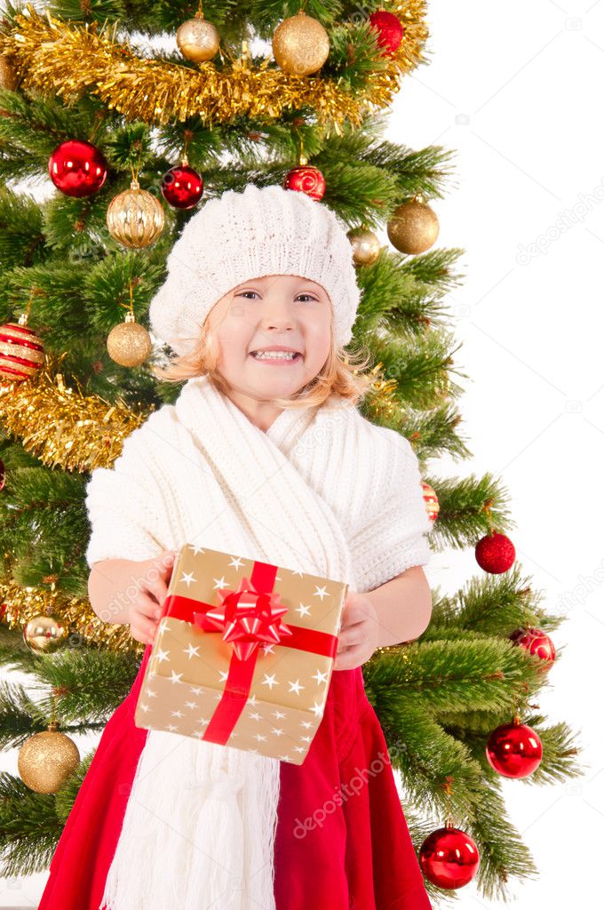 The portrait of the little child smiling and holding present box