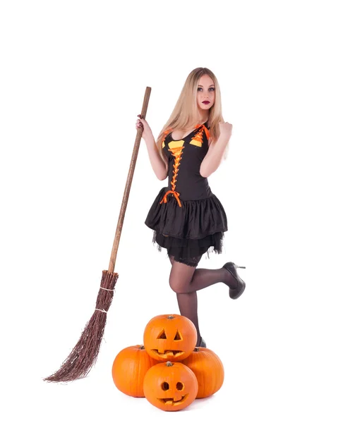 Halloween witch in dress with pumpkin, broom — Stock Photo, Image