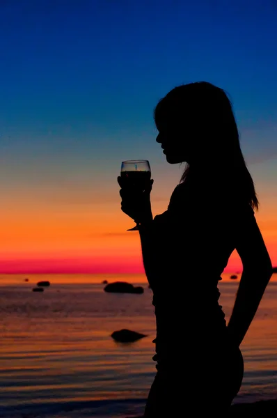 Silueta de mujer en la puesta de sol en la playa . — Foto de Stock