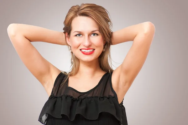 Beautiful woman posing and smiling coquettishly — Stock Photo, Image