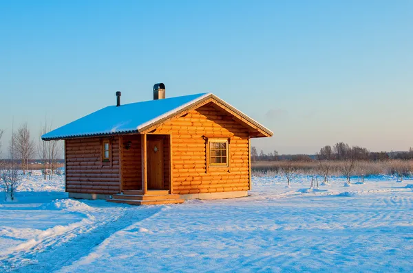 Wooden saun house in snow and frozen landscape Stock Image
