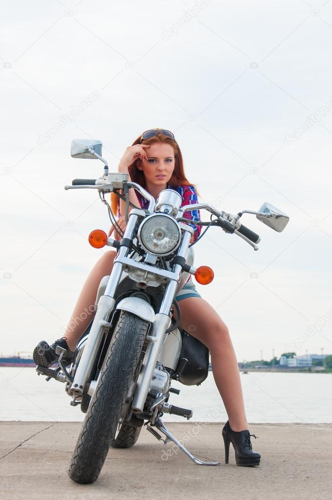 Beautiful, sexy, young woman on a motorcycle