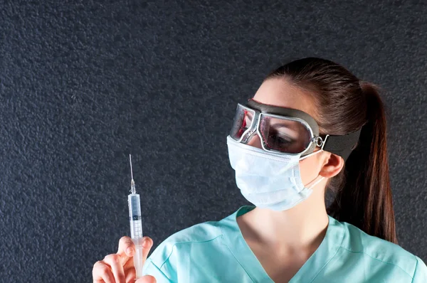 Nurse or doctor in pilot glasses with syringe — Stock Photo, Image