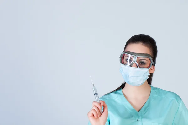 Nurse or doctor in pilot glasses with syringe — Stock Photo, Image