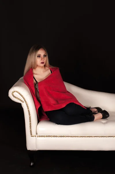 Blond woman on a white sofa — Stock Photo, Image