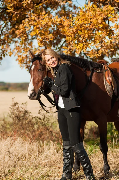 Beautiful woman walking with horse — Stock Photo, Image