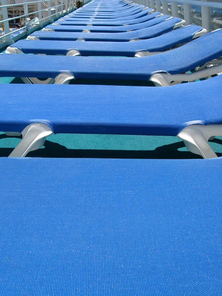 Blue abandoned sun loungers — Stock Photo, Image