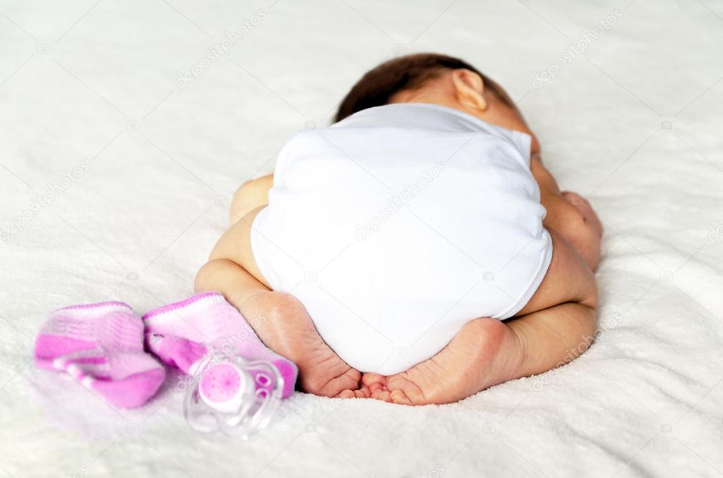 It's a girl! newborn baby. butt in a diaper, with a adorable crossed