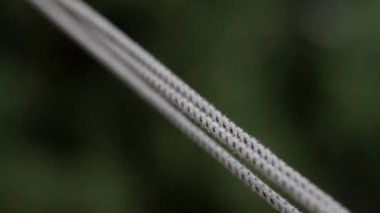 Clotheslines swing slowly in the air closeup. Shallow depth of field