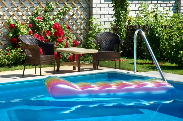 Pool with inflatable mattress — Stock Photo, Image