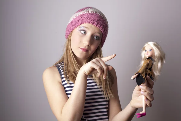 Teenage girl and doll. — Stock Photo, Image