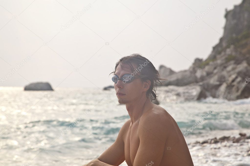 Man with goggles for swimming on the sea