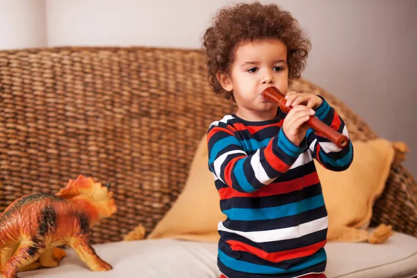 Boy playing musical instruments — Stock Photo, Image