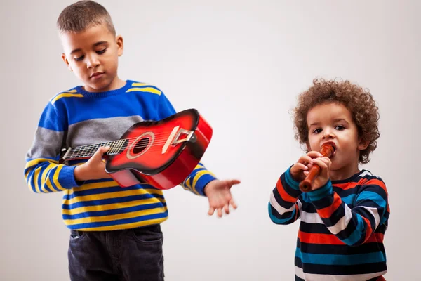 Boys playing musical instruments — Stock Photo, Image