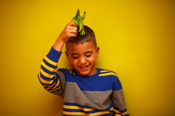 Afro American boy against yellow background — Stock Photo, Image