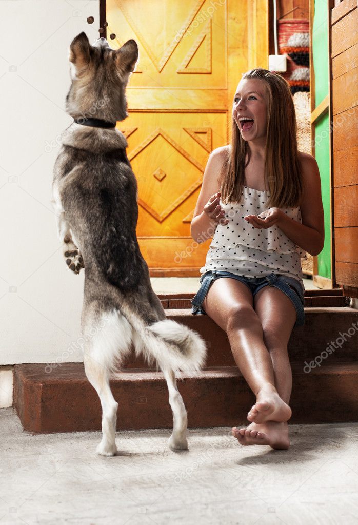 Teenage girl feeding dog