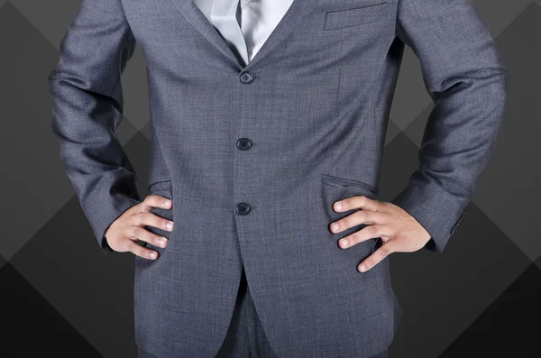 Businessman in suit, hands on hips — Stock Photo, Image