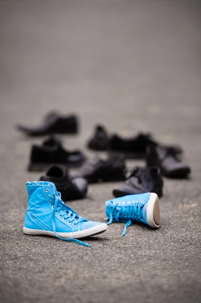 Blue sneakers on asphalt — Stock Photo, Image