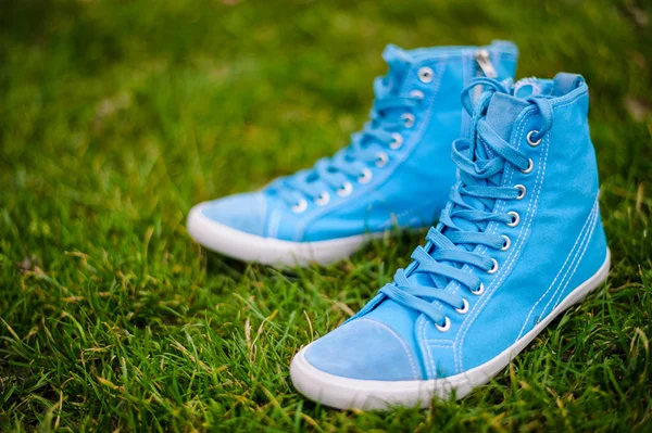 Blue sneakers on grass — Stock Photo, Image