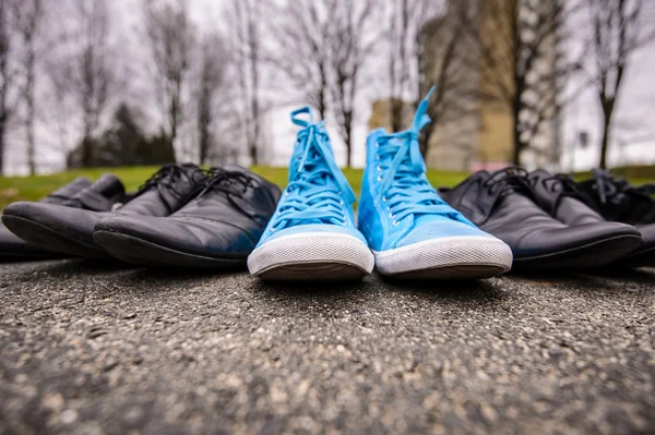 Blue sneakers on asphalt — Stock Photo, Image
